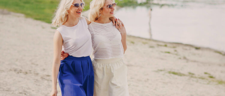 Healthy Young Adult twins walk the beach