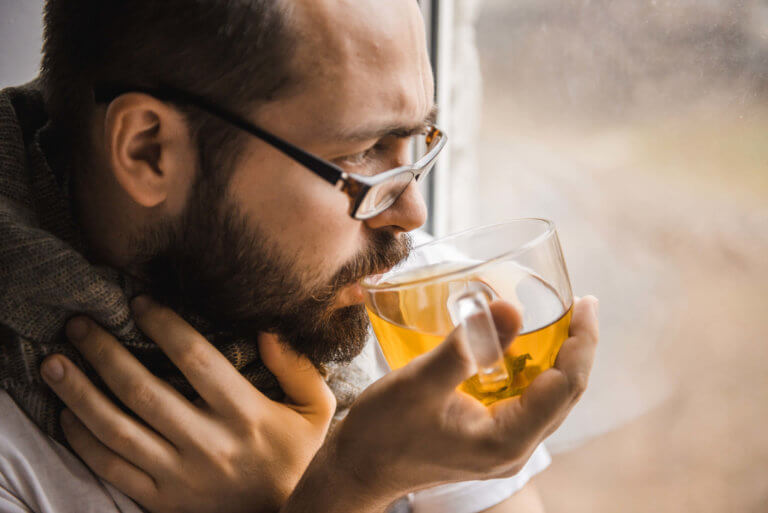 man drinks healing hot tea